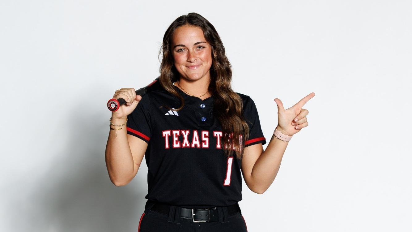 Jayden Heavener holding a cowboy hat on her head for a photo while on a recruiting visit