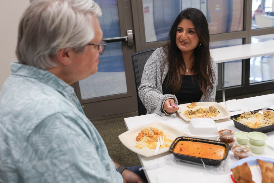 Ben Philpott and Syeda Carillo eat Pakistani food during a recording for ATXplained Live at the KUT studios on Thursday, Sept. 18, 2025.