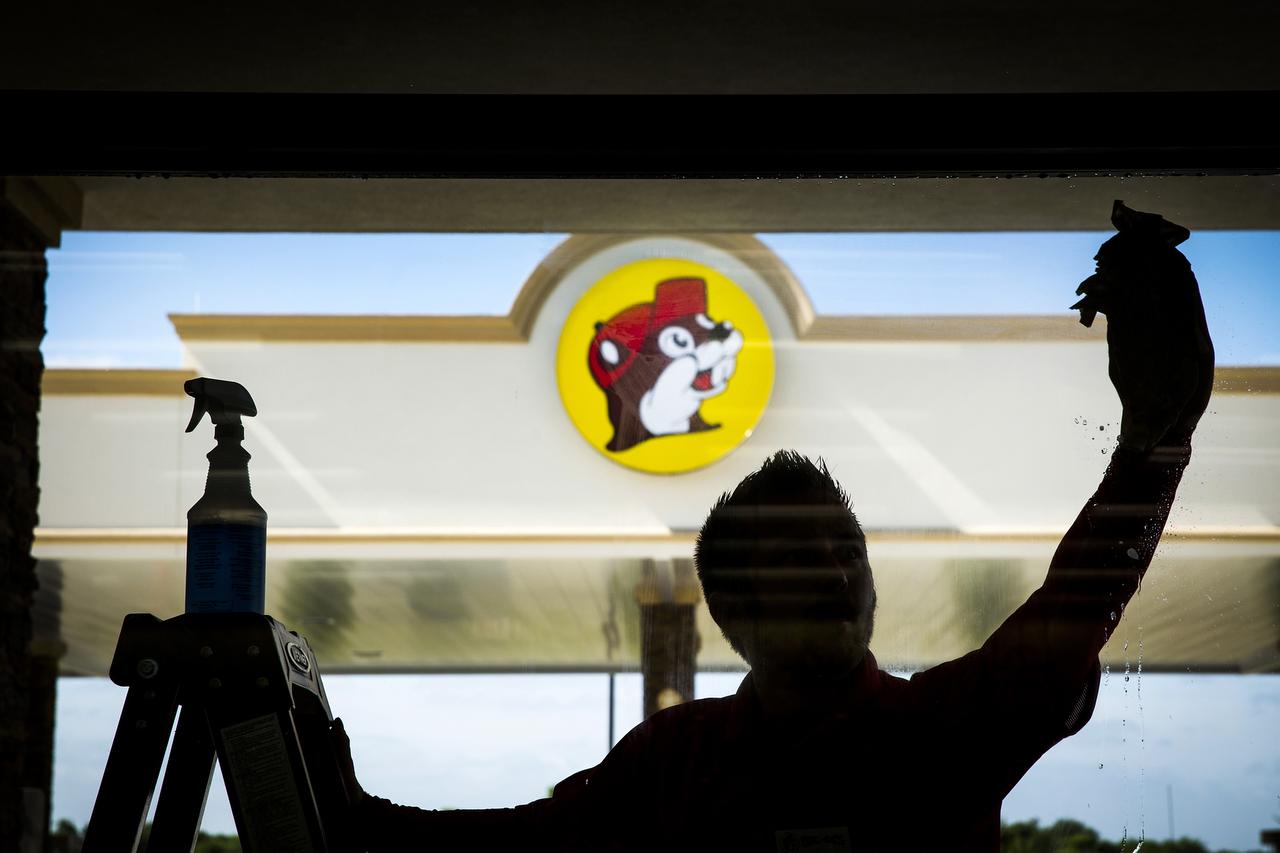 Sean Mizell washes windows for the opening of the Buc-ee’s in Terrell — the better to gaze out at the store’s 84 gas pumps and 19 acres of land, or to look in from outside at the 60,000 square feet of floor space.