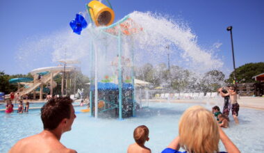 Brian Buchek, left, and Linda Buchek, right, watch as their family is soaked with an oversize bucket of water at the splash playground, during the grand opening of the Heights Family Aquatic Center, on July 12, 2013 in Richardson. The $4.4 million amenity complements the $11 million renovation of Heights Recreation Center, which was completed in May.