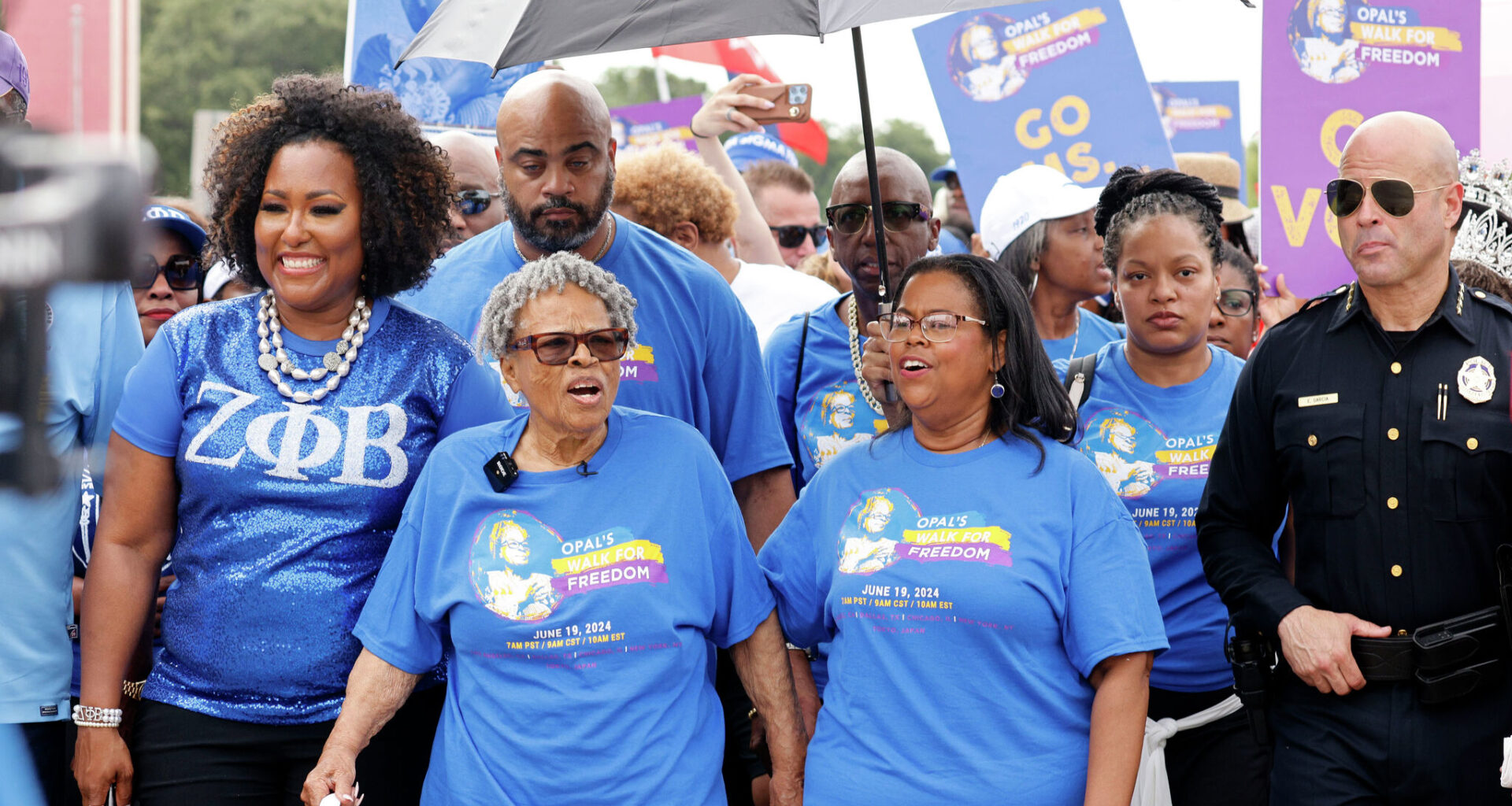 Opal Lee, the Grandmother of Juneteenth, second from left, walks through Fair Park with her granddaughter Dione Sims, third from left and hundreds of participants during 2024 Opal's Walk for Freedom honoring the U.S. federal holiday, Juneteenth, Wednesday, June 19, 2024, in Dallas.