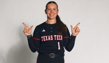 Bradi Gallaway posing with the 'guns up' symbol in a recruiting visist photoshoot