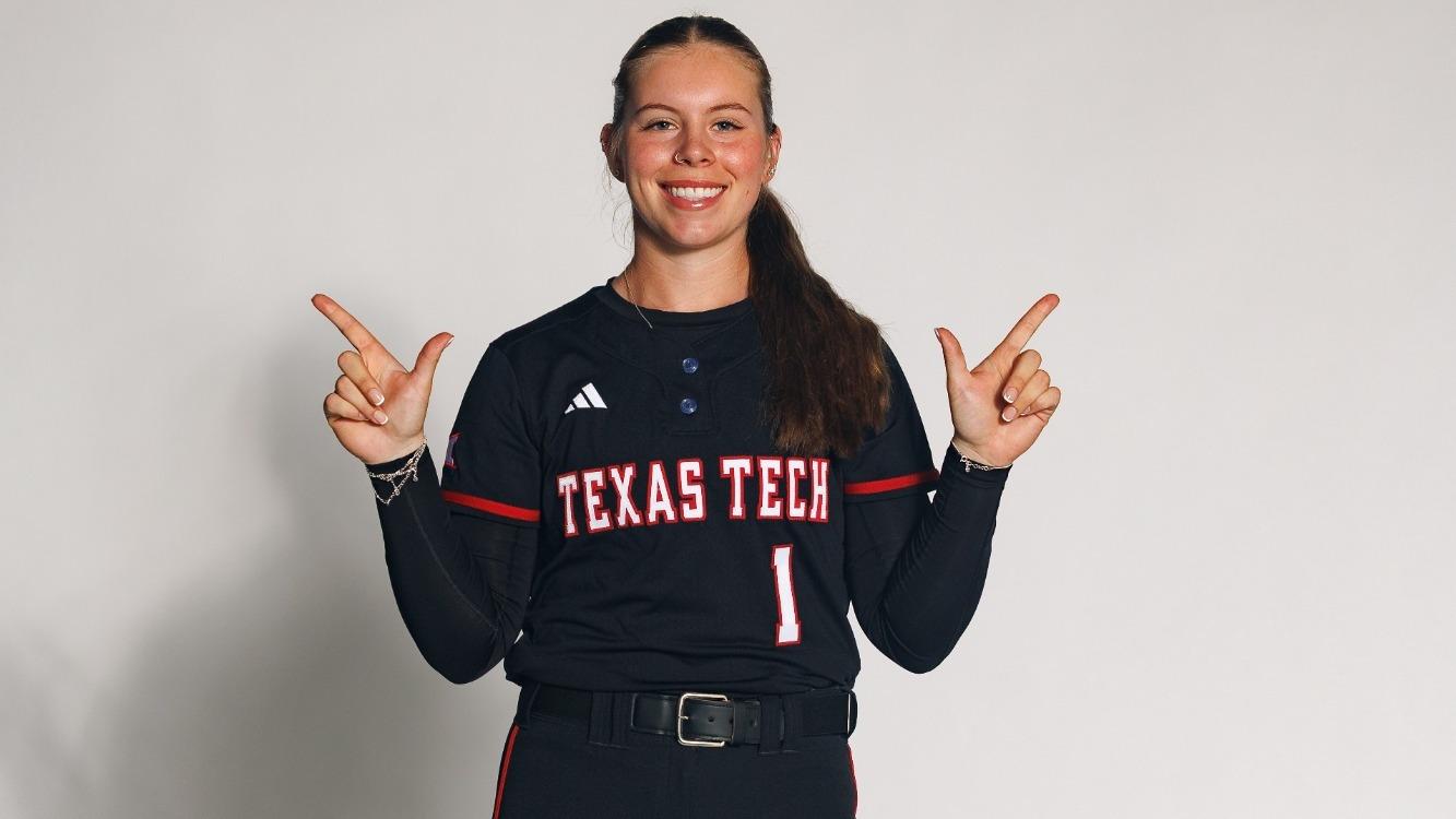 Bradi Gallaway posing with the 'guns up' symbol in a recruiting visist photoshoot