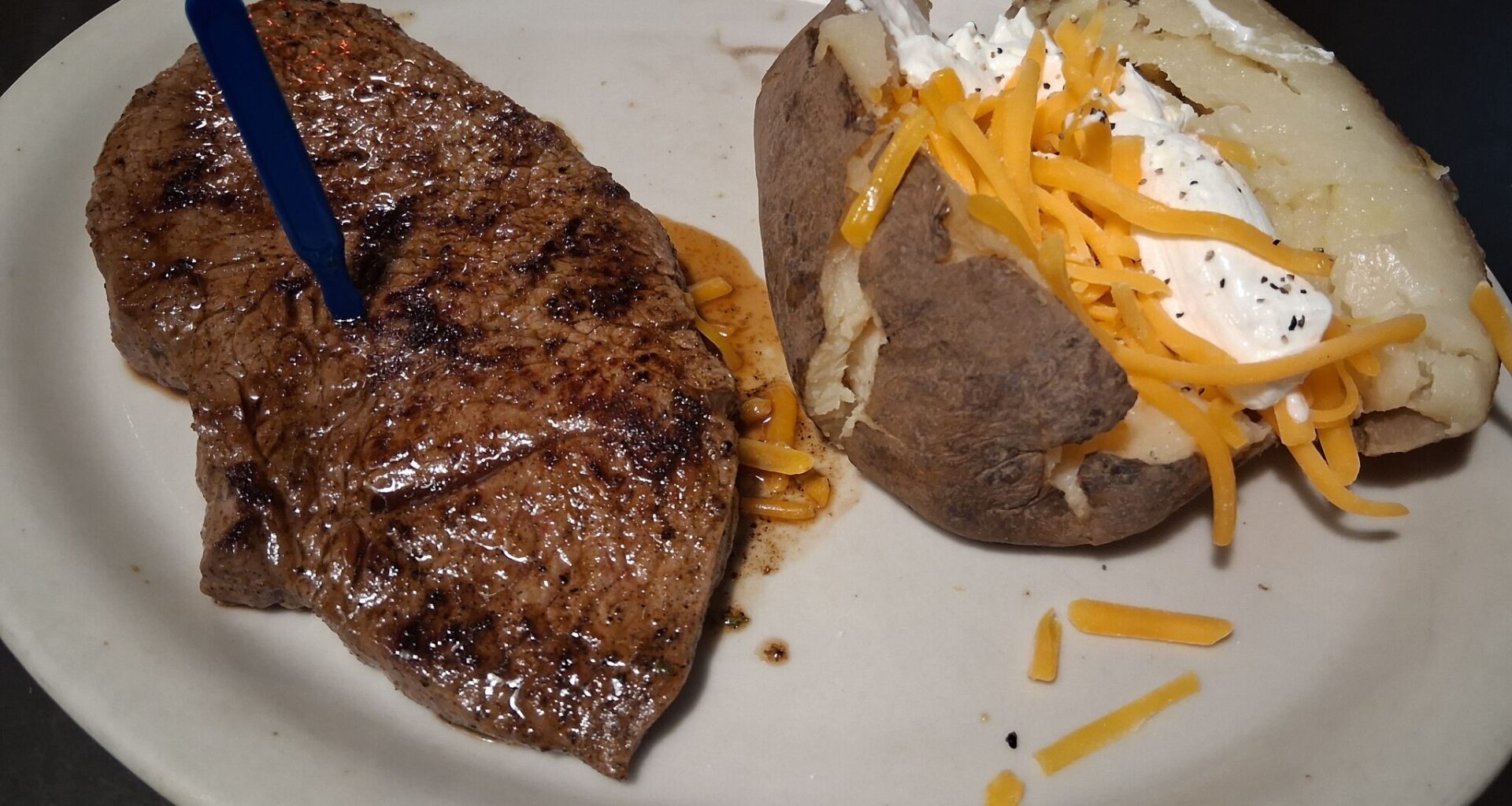 The house steak with a baked potato at the Hungry Farmer Steakhouse.