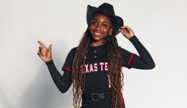 Hailey Maestretti doing the guns up pose at a photoshoot on a recruiting visit