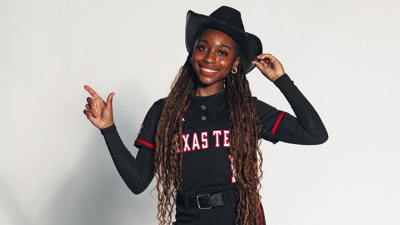 Hailey Maestretti doing the guns up pose at a photoshoot on a recruiting visit