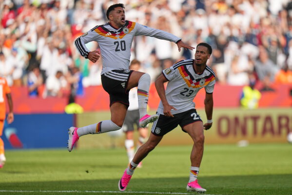 Germany's Nadiem Amiri leaps in the air as he celebrates after teammate Germany's Deniz Undav (26) scored their first goal during the World Cup Group E soccer match between Germany and Ivory Coast in Toronto, Saturday, June 20, 2026. (AP Photo/Stephanie Scarbrough)