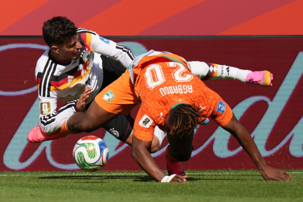 Germany's Kai Havertz, left, falls as he is tackled by Ivory Coast's Emmanuel Agbadou during the World Cup Group E soccer match between Germany and Ivory Coast in Toronto, Saturday, June 20, 2026. (AP Photo/Stephanie Scarbrough)