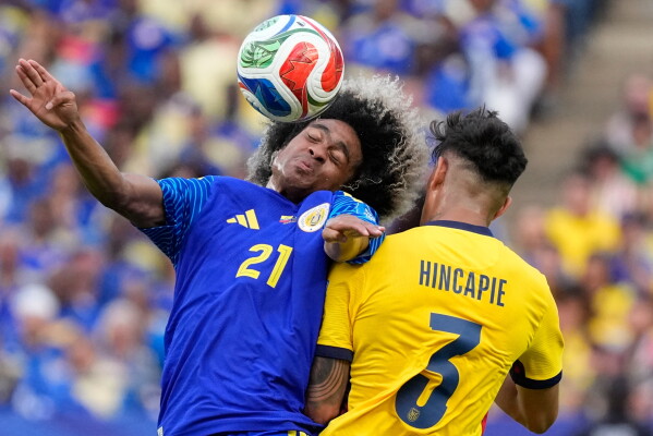 Curaçao's Tahith Chong, left, heads a ball next to Ecuador's Piero Hincapie during the World Cup Group E soccer match in Kansas City, Mo., Saturday, June 20, 2026. (AP Photo/Charlie Riedel)
