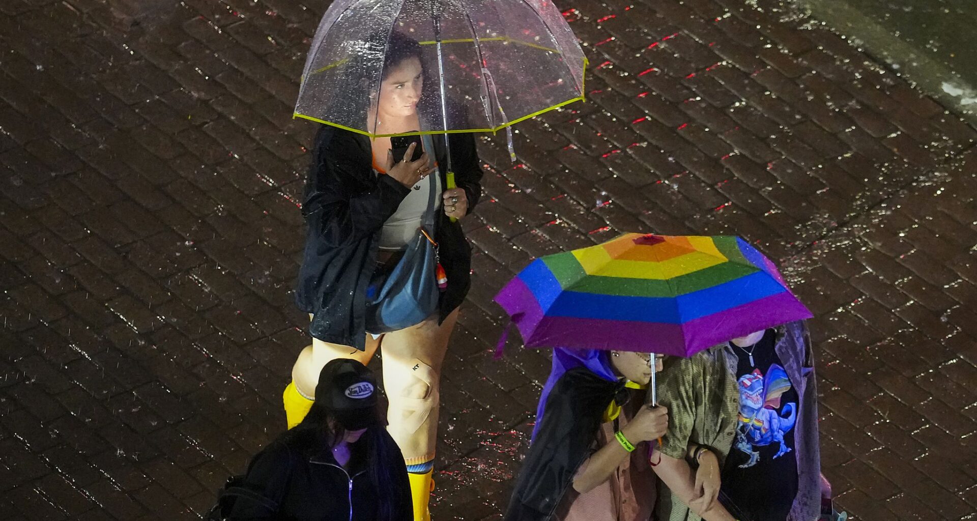 Rain falls as spectators depart after the Dallas Pride Sunset Parade in Dallas, Saturday, June 6, 2026.