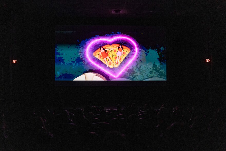 A short film is show on screen during Color Arc’s 4th annual storytelling show: Stories about Pizza at AFS Cinema on Thursday, June 18, 2026. Patricia Lim/KUT News