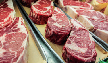 Close-up of large cuts of steak at a butcher shop.