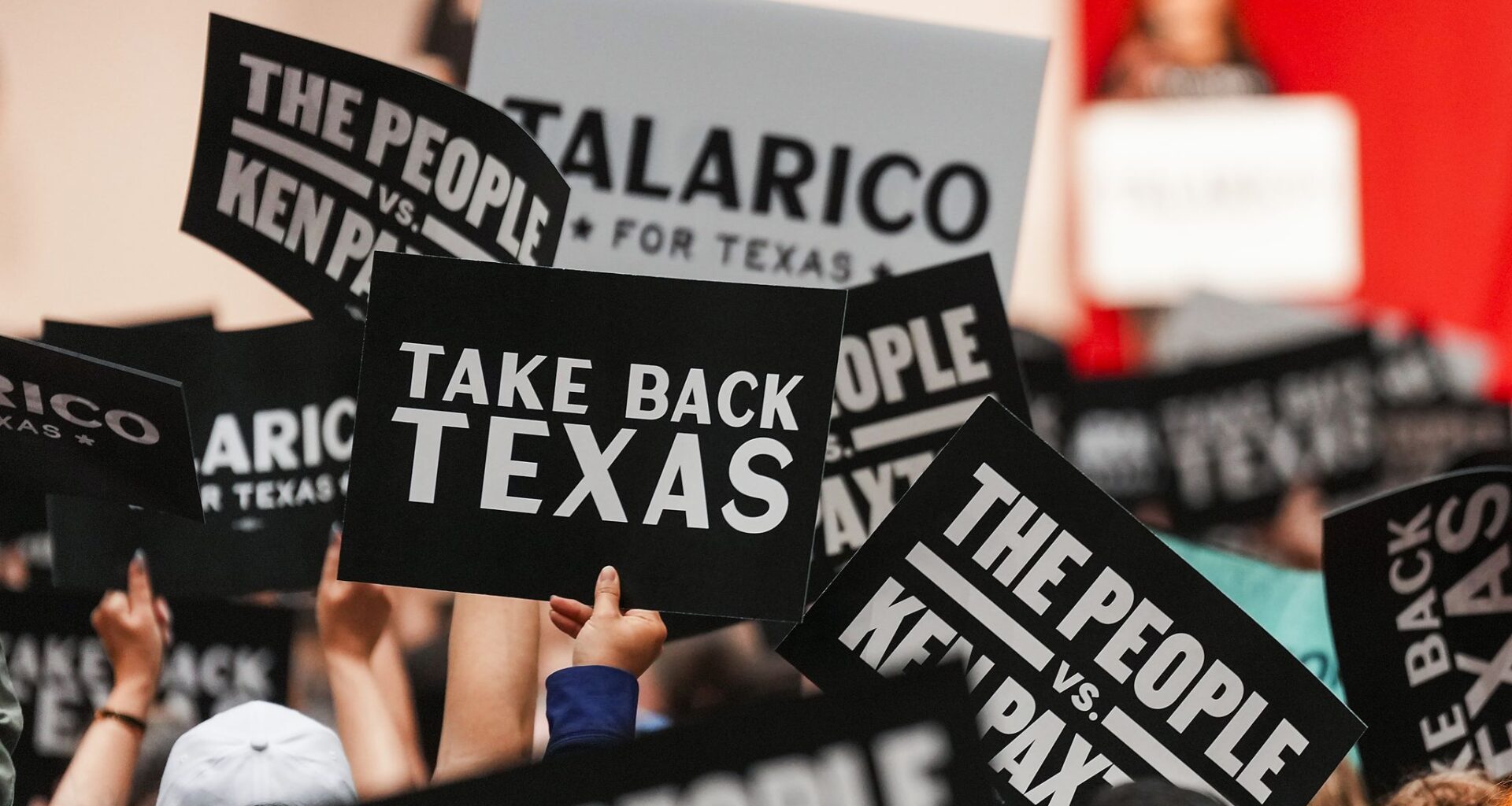 Supporters wave campaign signs before Democratic Senate candidate James Talarico addressed a rally June 1 in Plano.