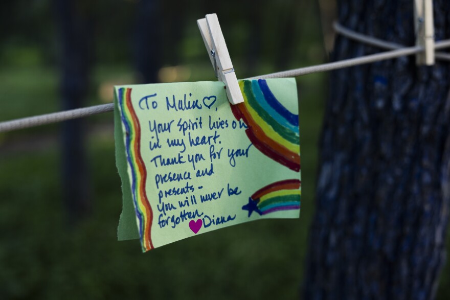 A message written on a piece of paper for Malin the Troll hangs on a piece of rope.