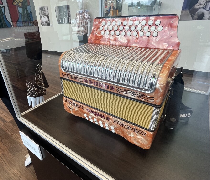 One of Flaco Jimenez's personal favorite accordions, the Orange Hohner Corona II, became closely tied to the sound of Conjunto music and to Flaco's instantly recognizable playing style. It's now encased in glass at the Common Ground Gallery at Alamo Colleges for the "From the West Side to the World: Un Homenaje a Flaco Jimenez" exhibit through July 31, 2026.