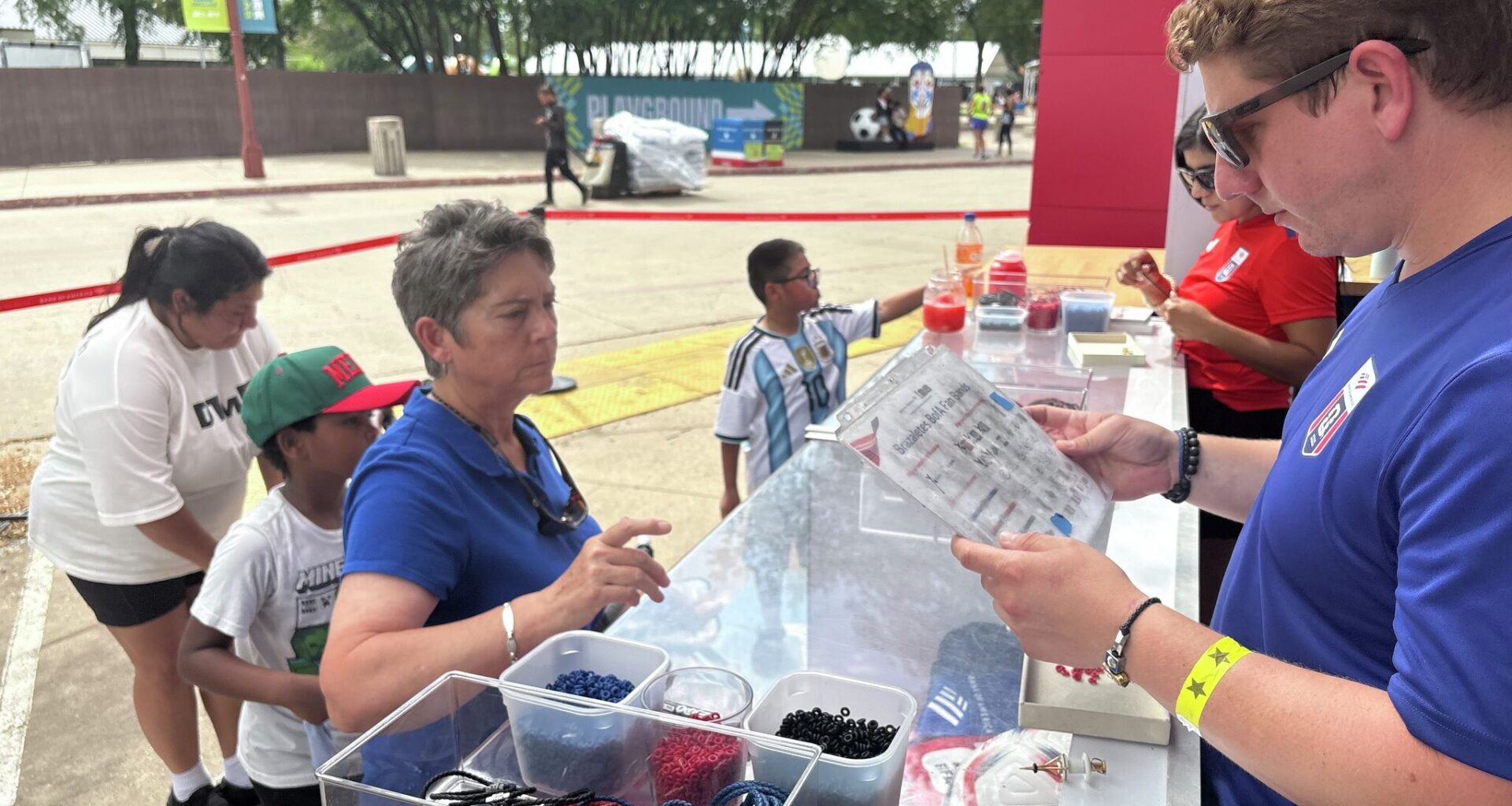 Fans wait in hours-long line for free bracelets at FIFA Fan Festival
