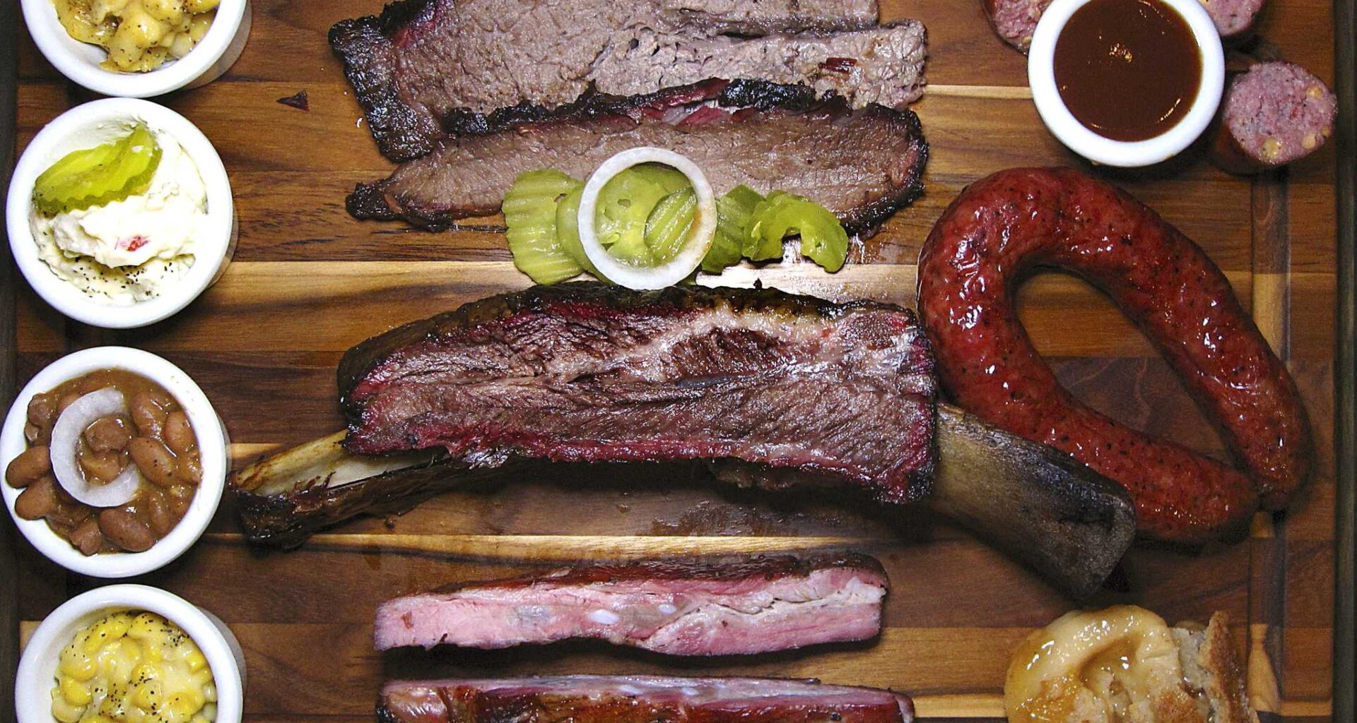 Barbecue and sides from The Original Black's Barbecue in New Braunfels. Clockwise from top left: mac and cheese, brisket, jalapeño-cheese sausage, beef sausage, peach cobbler, pork spare ribs, creamed corn, pinto beans, potato salad and a beef rib.