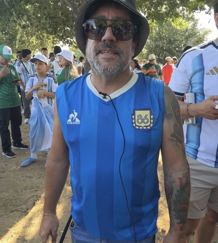 Erubi Rosas of Argentina holds a sign reading "I Buy Tickets" outside Dallas Stadium before the Argentina-Jordan World Cup match in Arlington on Saturday after traveling across the United States in hopes of seeing her national team play. 