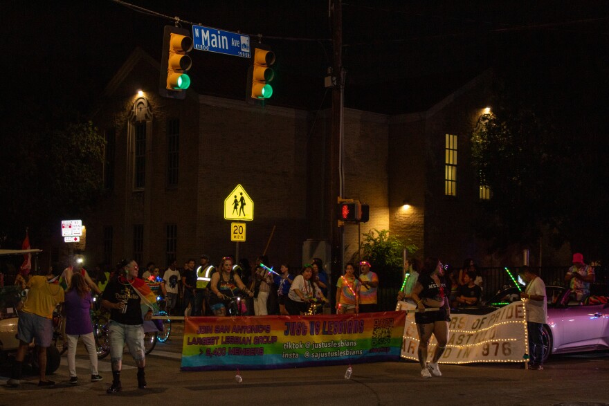 People gather on N Main Ave to begin the Pride Parade.