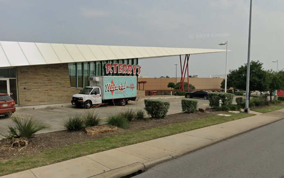 P. Terry's guests hold up complimentary T-shirts with a sign saying goodbye to the chain's Capital Plaza location off Interstate 35 in Austin on Friday, June 26. 