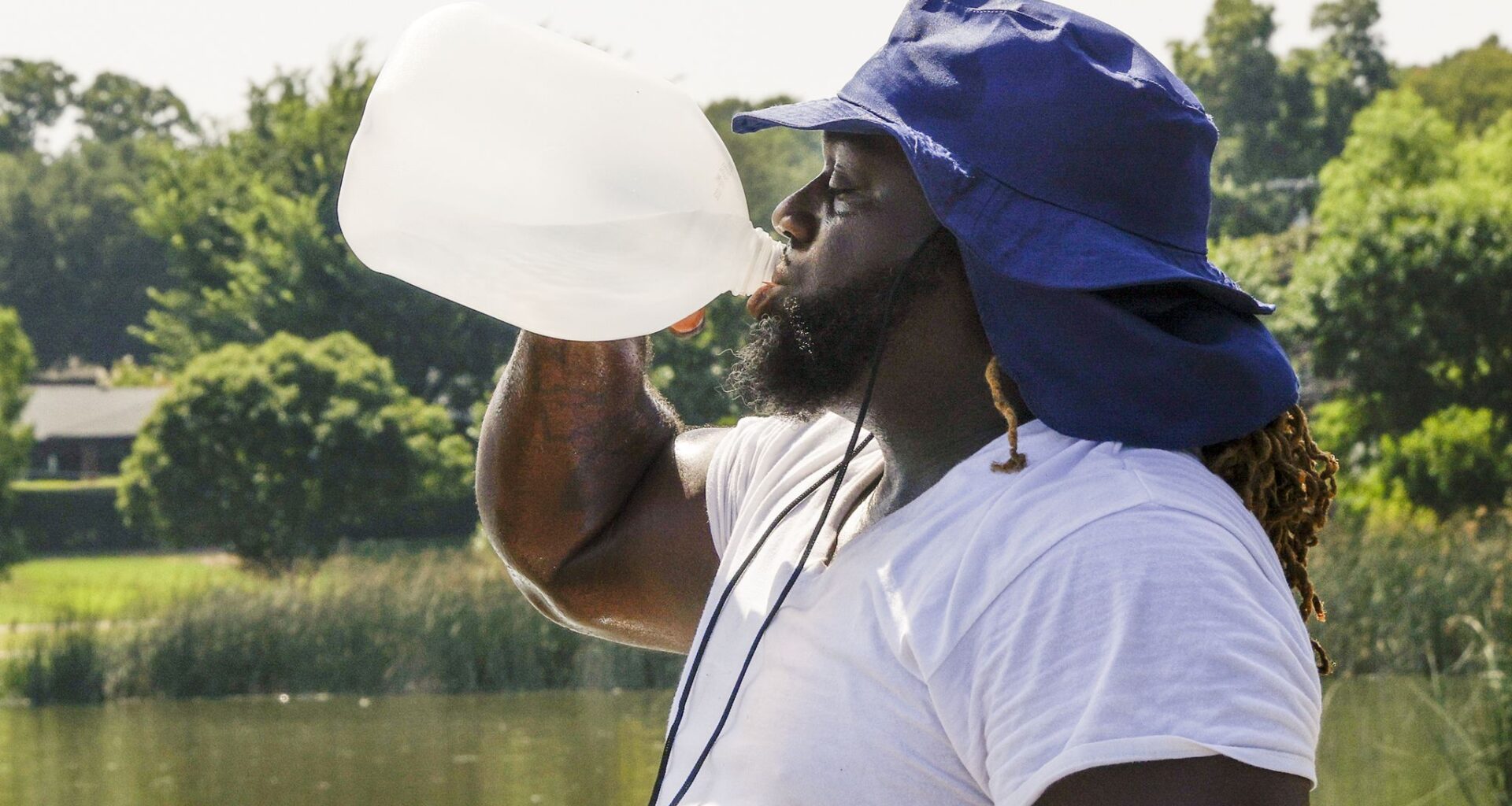 Alexander Nixon of Dallas drinks water while working out at White Rock Lake, Monday, July 17, 2023 in Dallas.