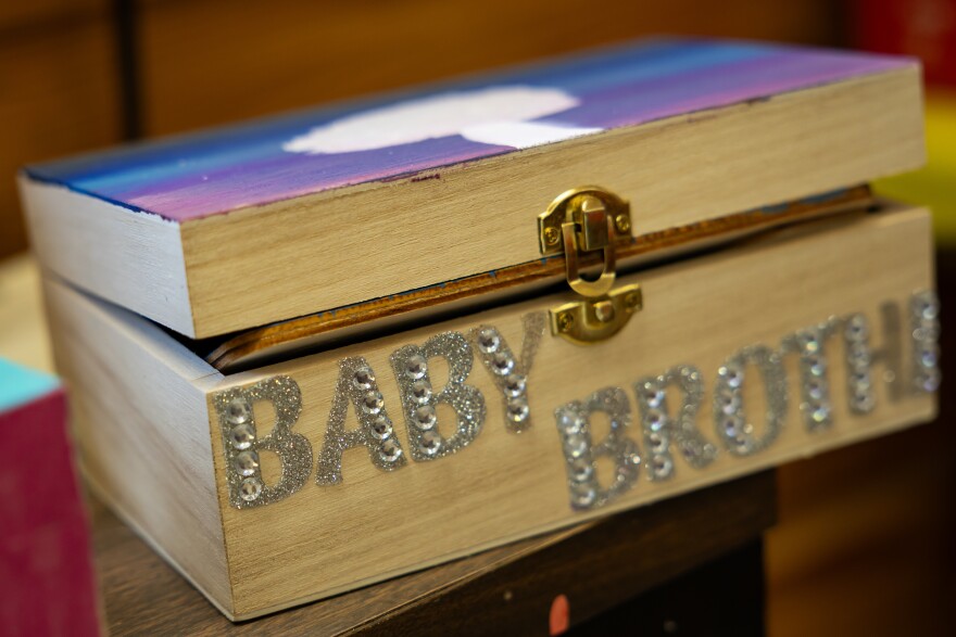 Photo of a small wooden box that says "Baby Brother" in silver lettering on the side