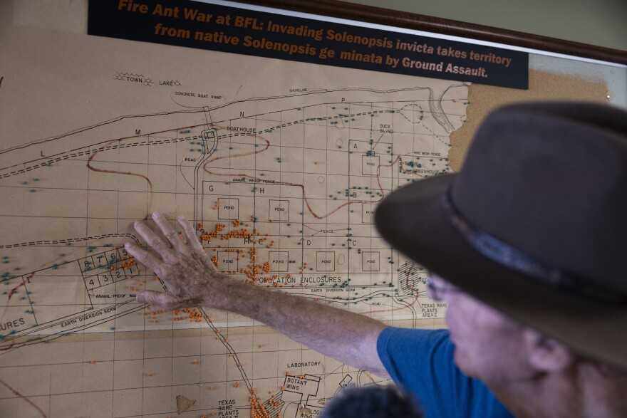 A man puts his hand on a map.