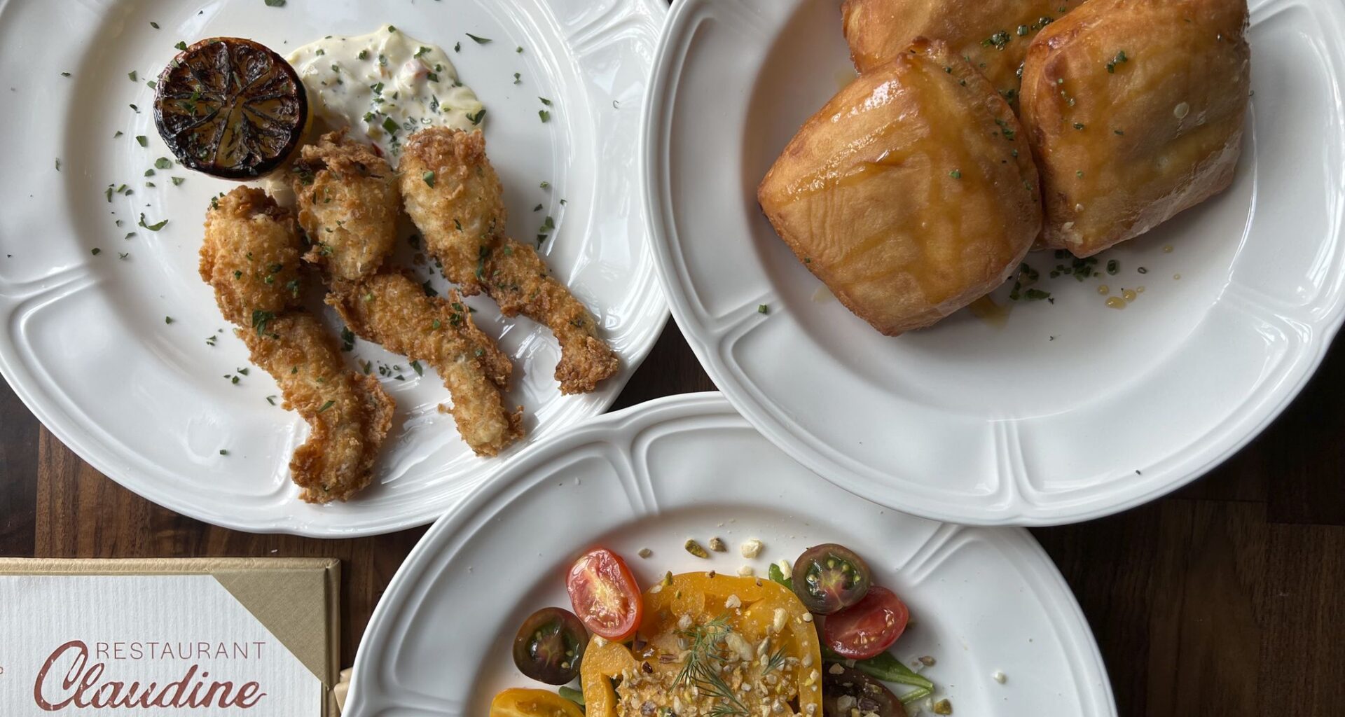 Fried frog legs, blue crab beignets and an heirloom tomato salad at Restaurant Claudine in Government Hill in San Antonio.