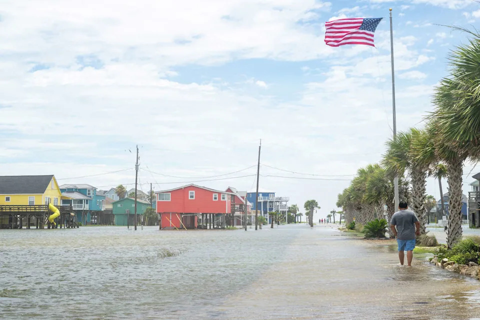 A person walks through a flooded neighborhood after Tropical Storm Arthur made landfall on June 17, 2026 in Freeport, Texas. Soaring temperatures hit the Lone Star State after the storm pushed out. (Brandon Bell/Getty Images)