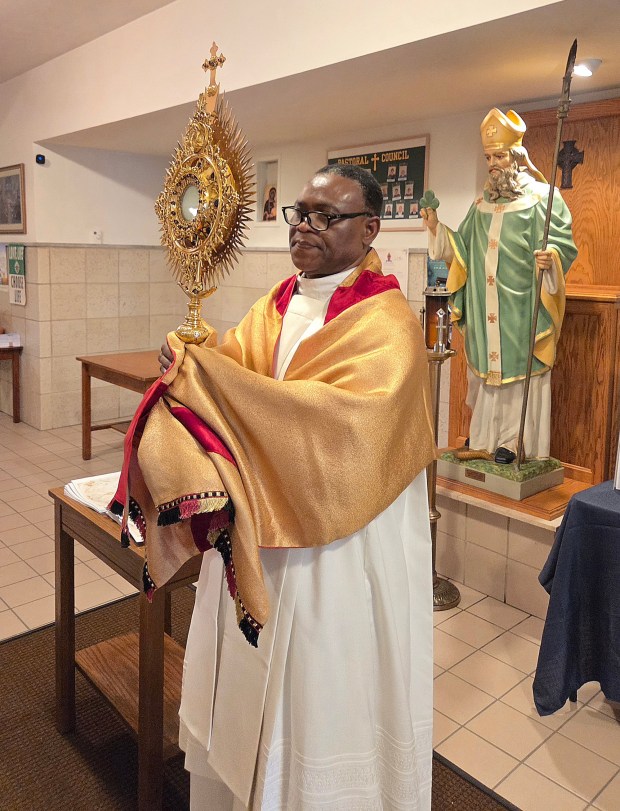 Rev. Hubert Asante Kumi , St. Patrick Catholic Church assistant pastor, at Corpus Christi service on June 7, 2026. RON DEVLIN/STAFF PHOTO
