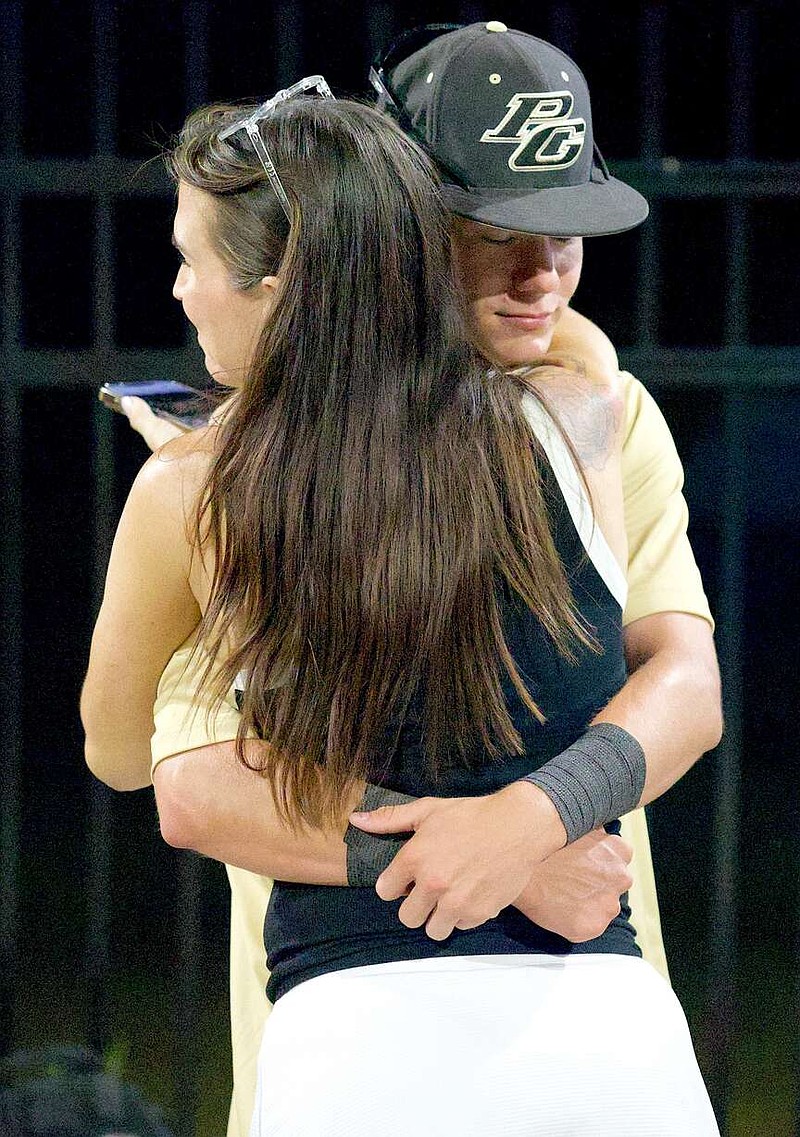 Pleasant Grove baseball player Evan Heintschel hugs his mother, Jo, on Friday night, June 5, 2026, as the Hawks return home after winning the Class 4A, Division 1 state baseball championship earlier in the day in Round Rock, Texas. Pleasant Grove defeated Corpus Christi Calallen, 2-1. (Staff photo by Stevon Gamble)