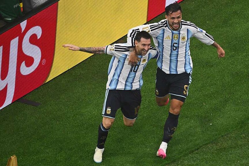 Argentina's Lionel Messi, left, is congratulated by Leandro Paredes after scored during the World Cup Group J soccer match between Argentina and Austria in Arlington, Texas, near Dallas, Monday, June 22, 2026. (AP Photo/Jessica Tobias)