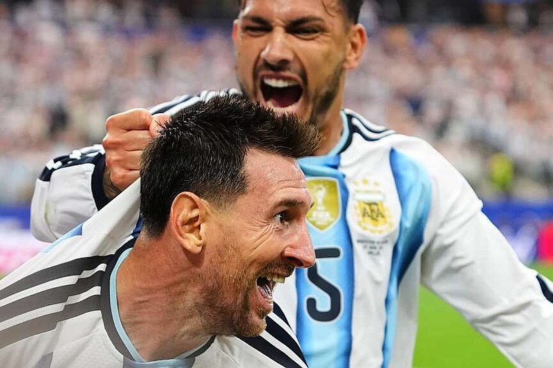 Argentina's Lionel Messi, front, celebrates with Leandro Paredes after scoring his side's second goal during the World Cup Group J soccer match between Argentina and Austria in Arlington, Texas, near Dallas, Monday, June 22, 2026. (AP Photo/Julio Cortez)