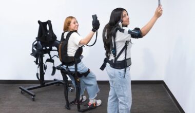 UTEP student Juliana Guevara Mendoza, left, wears a grip strength support device (Ironhand) and the sit-stand support exoskeleton (Chairless Chair), while Jessica Sanchez-Balandran works with a shoulder support exoskeleton (Skelex). The team recently conducted a study on barriers to workplace exoskeleton use.