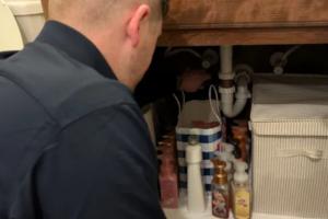 licensed plumber from Mother Modern Plumbing performs home drain cleaning service in Plano, TX bathroom