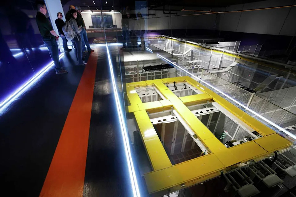 People on a group tour look down into Dallas TX1 data center's server vault at the NTT Data center campus in Garland, Texas, March 4, 2026. (Tom Fox/Staff Photographer)