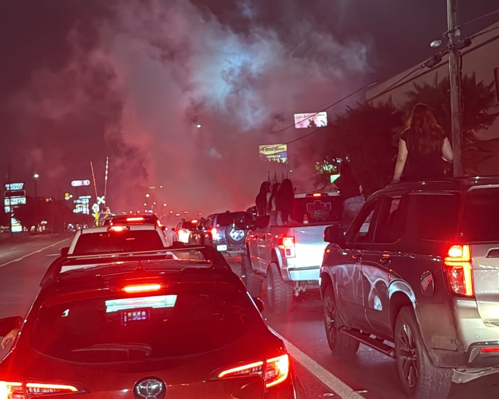 traffic jam with vehicles and individuals on top amid smoke traffic jam with vehicles and individuals on top amid smoke