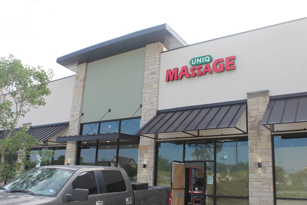 Image of Uniq Massage sign above entrance.