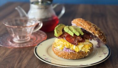 Bagel breakfast sandwich, tea cup, tea pot