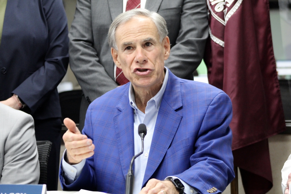 Gov. Greg Abbott, wearing a blue jacket and shirt, speaks to press June 5.