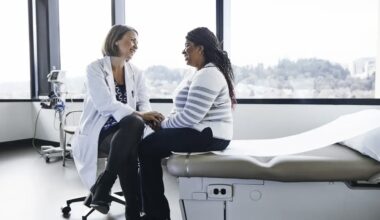 Doctor and patient speaking in front of windows