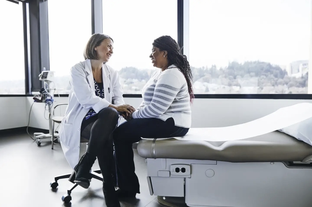 Doctor and patient speaking in front of windows