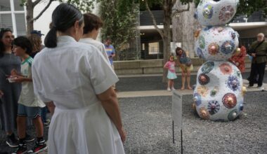 Onlookers view the newly unveiled "Mosaic of Minds" sculpture, permanently located at the AISD Performing Arts Center at 1500 Barbara Jordan Blvd. (Jessica McLaren/Community Impact)