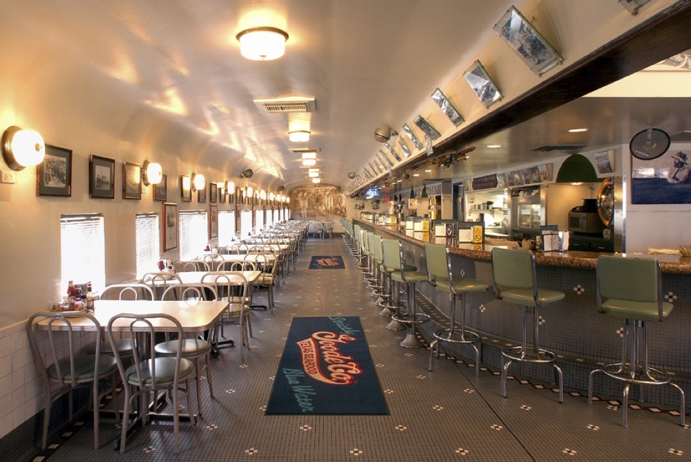 Classic diner-style restaurant with tables on the left side of the building, bar seating on the right side