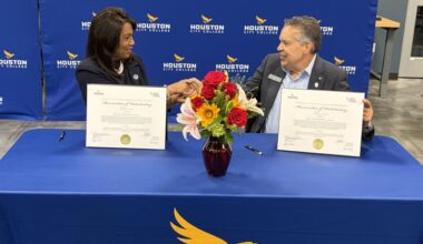 HCC Chancellor Margaret Ford Fisher (left) and William Harris, president and CEO of Space Center Houston, shake hands after signing the memorandum of understanding. (Bradley Dountz/Community Impact)