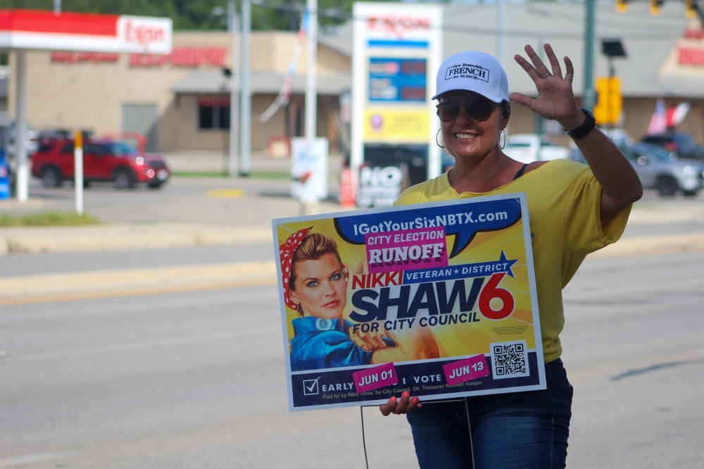 New Braunfels City Council District 6 candidate Nikki Shaw campaigns outside city hall on June 13. (Amira Van Leeuwen/Community Impact)