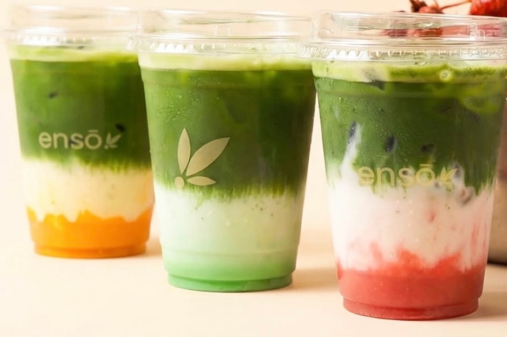 Three matcha beverages in a diagonal line, each with a different drink base