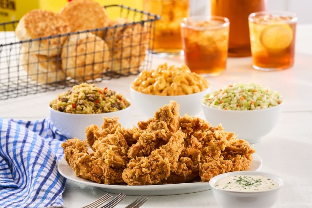 a table full of chicken and sides