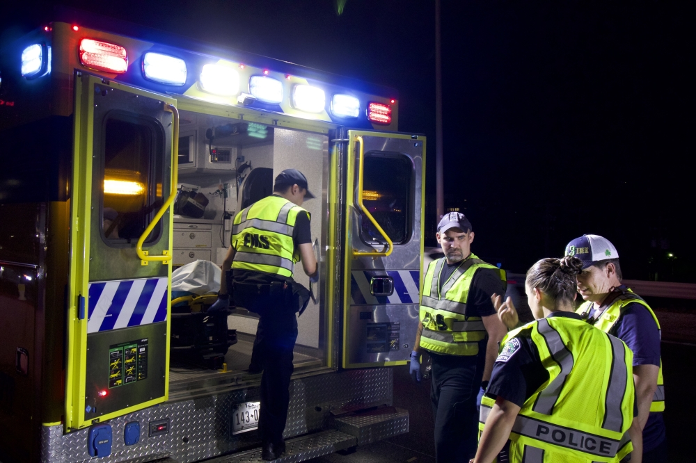 Emergency medical service personnel discuss an incident with a police officer. (Courtesy Austin-Travis County Emergency Medical Services)