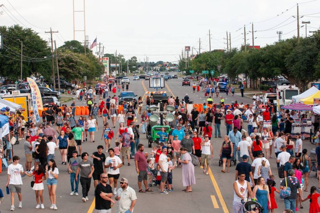 Image shows the Tomball 4th of July street festival with crowded streets.